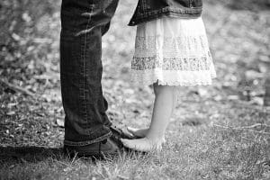 Black and White of Daughter standing on Dad's shoes