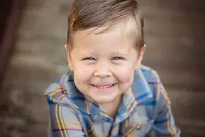 Boy smiling with flannel for outdoor photo shoot