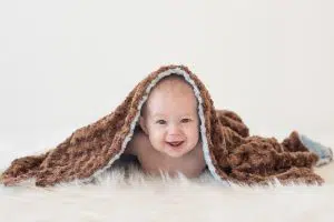 Happy baby photo on fur rug