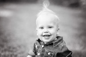Fun black and white Kid Picture of baby boy with smile.