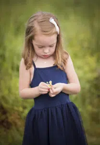 Girl holding flowers during photography session.