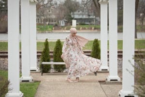 Girls dress moving in the wind during senior photos at Sinnissippi Gardens in Rockford, IL