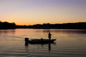 Silhouette of guy fishing at Rock Cut State Park at sunset.