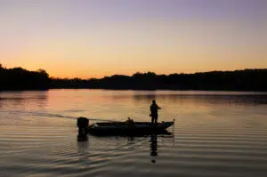Silhouette of guy fishing at Rock Cut State Park at sunset.